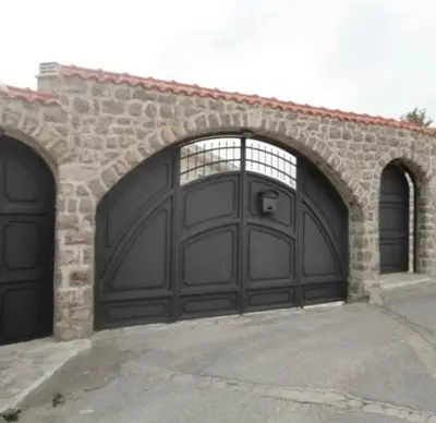 a pair of garage doors on a stone building at Vila Reževići in Budva