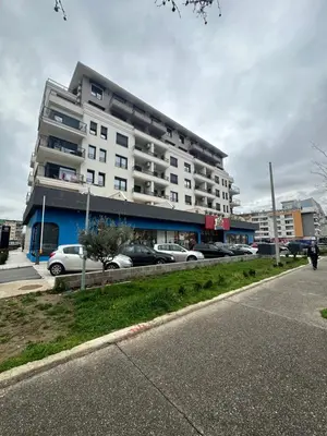 a large white building with cars parked in front of it at Irina Centre apartment in Podgorica