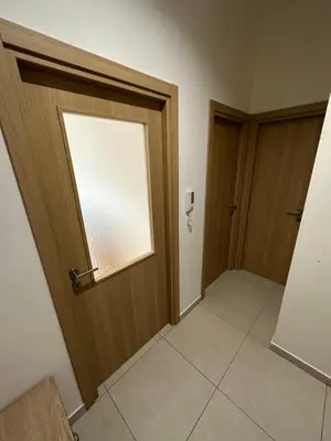 an empty hallway with a door and a window at Irina Centre apartment in Podgorica