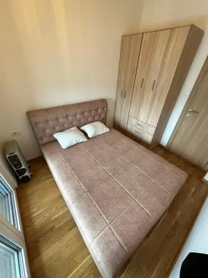 a bed with two pillows on it in a room at Irina Centre apartment in Podgorica