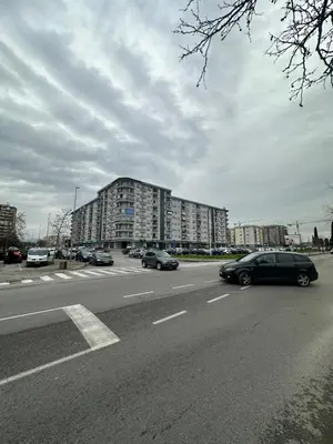 a street with cars driving down a road with buildings at Irina Centre apartment in Podgorica