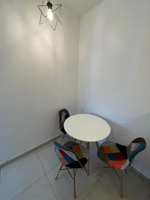 a dining room with a table and two chairs at Irina Centre apartment in Podgorica