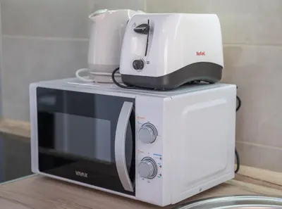 a microwave with a coffee maker on top of it at Apartment Adriana in Kotor