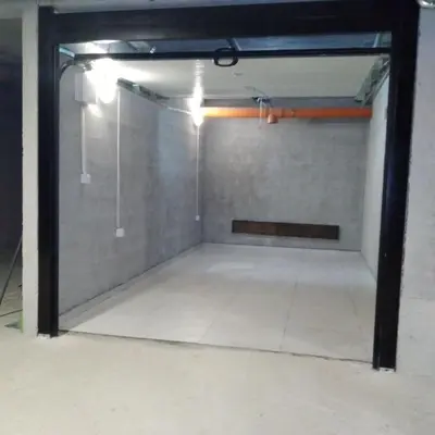 an empty garage with a glass door and a tile floor at Apartment Adriana in Kotor