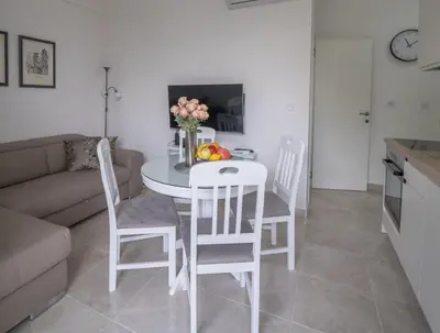 a white table and chairs in a living room at Apartment Adriana in Kotor