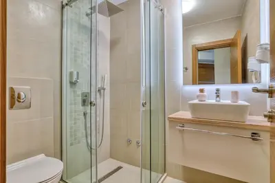 a bathroom with a shower and a toilet and a sink at Symphony Apartments Street View in Petrovac na Moru