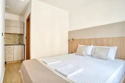 a bedroom with a large white bed with white pillows at Symphony Apartments Street View in Petrovac na Moru