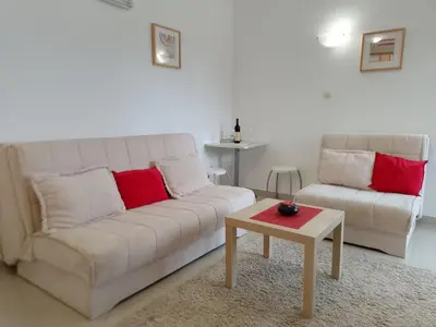 a living room with a couch and a coffee table at Splendid studio apartment in Becici