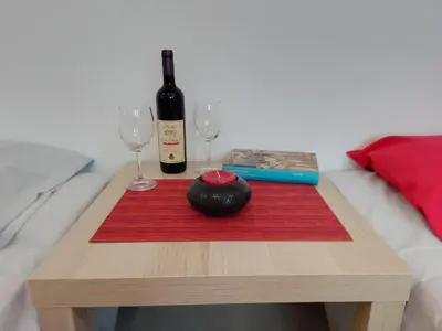 a table with a bottle of wine and two glasses at Splendid studio apartment in Becici