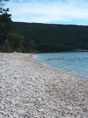 a large group of rocks on a beach near the water at Summer Beach House in Ulcinj