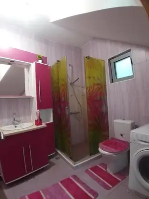 a bathroom with a shower and a toilet and a sink at Summer Beach House in Ulcinj