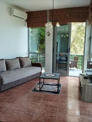 a living room with a couch and a table at Summer Beach House in Ulcinj