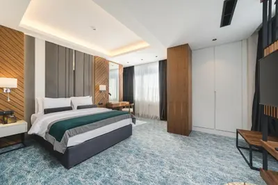a hotel room with a bed and a television at Bristol Hotel Podgorica in Podgorica