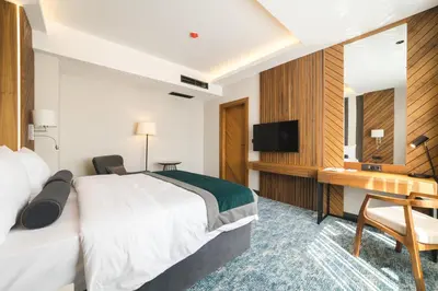 a hotel room with a bed and a desk at Bristol Hotel Podgorica in Podgorica
