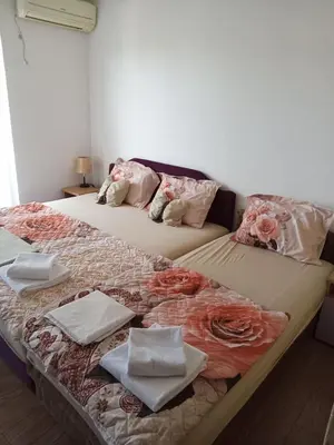 a bedroom with two beds with towels on them at Perper in Sutomore