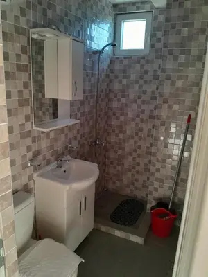 a small bathroom with a sink and a shower at Perper in Sutomore