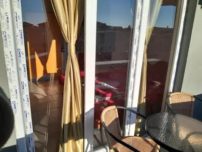 a room with a glass door with a table and a window at Perper in Sutomore