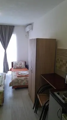 a small room with a bed and a cabinet at Perper in Sutomore