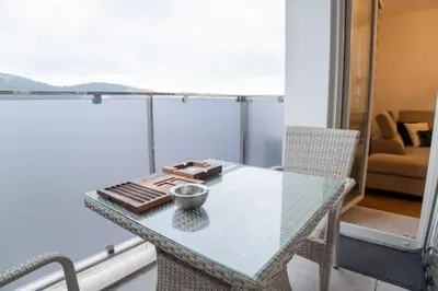 a glass table with a bowl on it on a balcony at Luxury AMAAA Apartment in Bar