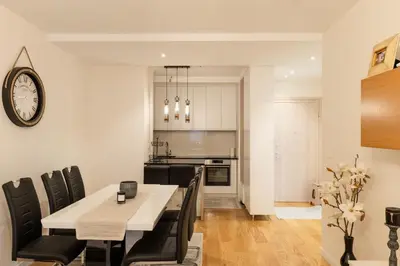 a kitchen and dining room with a table and chairs at Luxury AMAAA Apartment in Bar