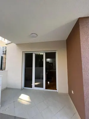an empty room with a large sliding glass door at SKY Apartment in Budva