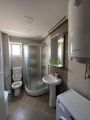 a bathroom with a shower and a toilet and a sink at SKY Apartment in Budva