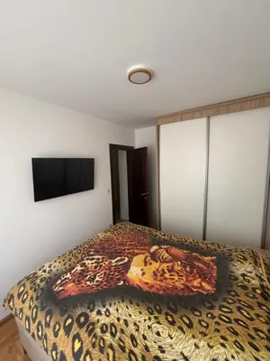 a bedroom with a leopard print bed with a flat screen tv at SKY Apartment in Budva