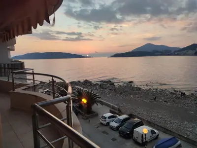 a group of cars parked next to a body of water at Luxury Apartment Astelmn in Budva
