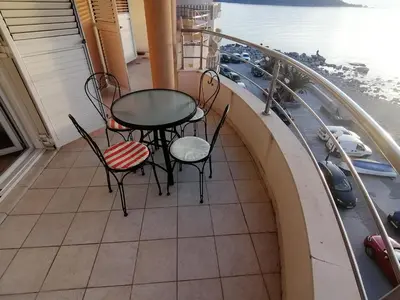 a balcony with two chairs and a table on a balcony at Luxury Apartment Astelmn in Budva