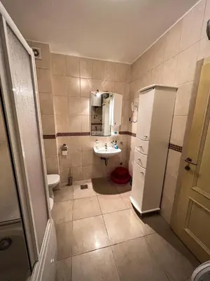 a bathroom with a sink and a white refrigerator at Luxury Apartment Astelmn in Budva
