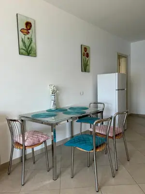 a kitchen with a table and chairs and a refrigerator at Luxury Apartment Astelmn in Budva