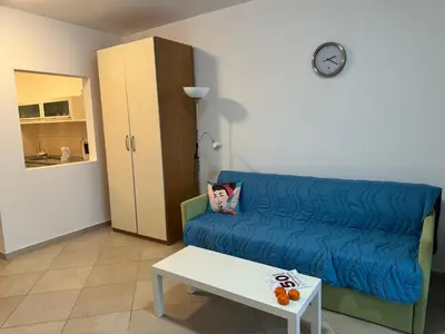 a living room with a blue couch and a table at Luxury Apartment Astelmn in Budva