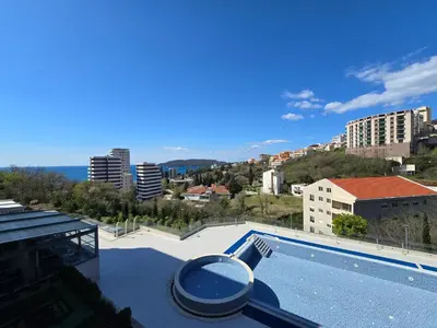 a swimming pool with a view of a city at Стильная квартира с видом на море и библиотекой in Becici