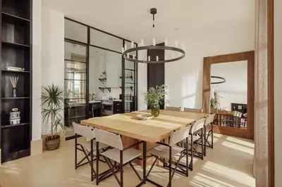 a dining room with a wooden table and chairs at Eterno Villas in Budva