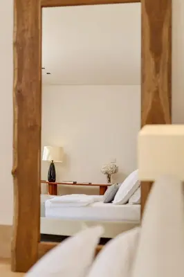 two beds in a room with a mirror at Eterno Villas in Budva