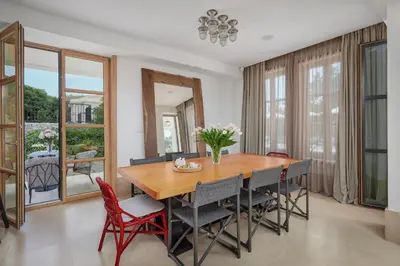 a dining room with a wooden table and chairs at Eterno Villas in Budva