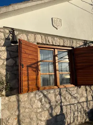 a window on the side of a stone building at Rustic House Montenegro in Bar