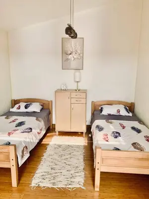 a bedroom with two beds and a dresser in it at Dream Apartments in Dobra Voda