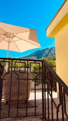a patio with an umbrella and a table and chairs at Dream Apartments in Dobra Voda