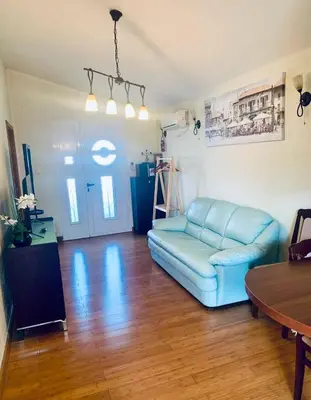 a living room with a blue couch and a table at Dream Apartments in Dobra Voda