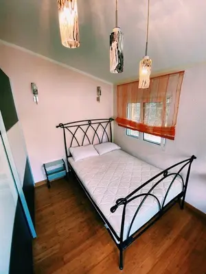a bedroom with a black bed in a room at Dream Apartments in Dobra Voda