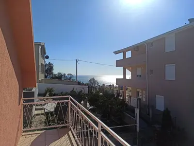 a view of the beach from the balcony of a building at Apartment Dubrava 112 in Dobra Voda
