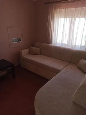 a living room with a couch and a window at Apartment Dubrava 112 in Dobra Voda