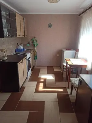a kitchen with wooden floors and a kitchen with a table at Apartment Dubrava 112 in Dobra Voda