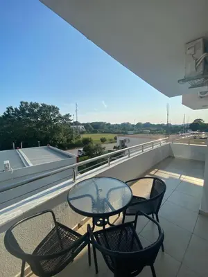 a balcony with a table and chairs on a roof at Ajan Apartments in Ulcinj