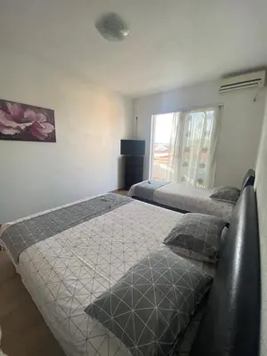 a bedroom with two beds and a window at Ajan Apartments in Ulcinj