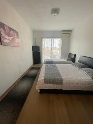 a bedroom with two beds and a window at Ajan Apartments in Ulcinj