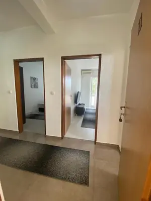 a hallway with two doors and a living room at Ajan Apartments in Ulcinj