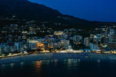 a view of a city with a beach at night at Casa Costa in Dobra Voda