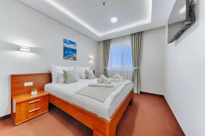 a bedroom with a large bed and a window at Casa Costa in Dobra Voda